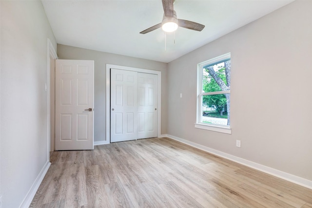 5858 Beldart St, Houston, TX 77033 - unfurnished bedroom with light wood-style floors, baseboards, a closet, and a ceiling fan