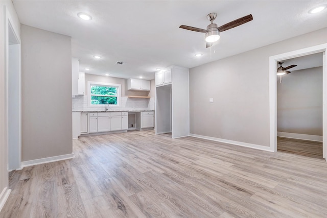 5858 Beldart St, Houston, TX 77033 - unfurnished living room featuring ceiling fan, a sink, light wood-type flooring, recessed lighting, and baseboards