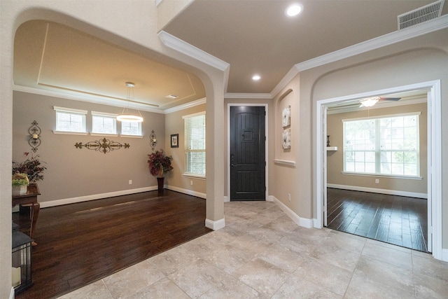 27619 Dalton Bluff Ct, Katy, TX 77494 - foyer with crown molding, arched walkways, a ceiling fan, baseboards, and wood finished floors