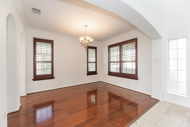 3604 Dogwood Blossom Ct, Pearland, TX 77581 - spare room with a chandelier, crown molding, arched walkways, and wood finished floors