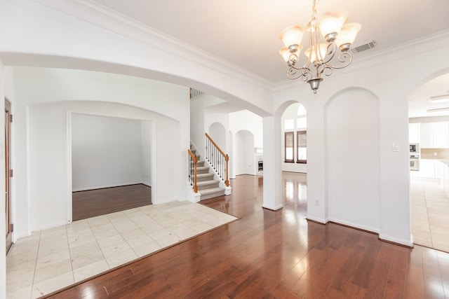3604 Dogwood Blossom Ct, Pearland, TX 77581 - entryway featuring arched walkways, a chandelier, hardwood / wood-style flooring, crown molding, and stairs