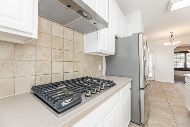3604 Dogwood Blossom Ct, Pearland, TX 77581 - kitchen with exhaust hood, stainless steel appliances, white cabinets, light countertops, and light tile patterned floors