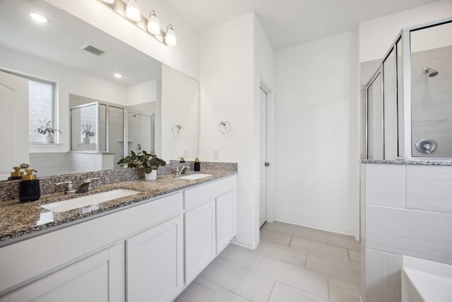 8018 Royal Palm Dr, Fulshear, TX 77441 - full bathroom featuring a shower stall, double vanity, and baseboards