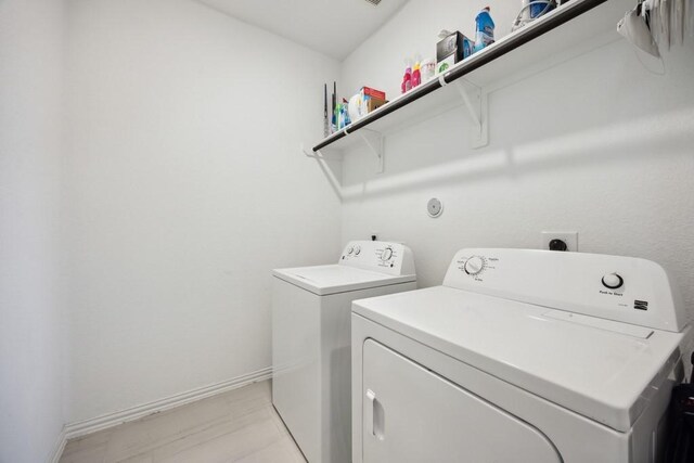 8018 Royal Palm Dr, Fulshear, TX 77441 - laundry room with washing machine and clothes dryer and baseboards