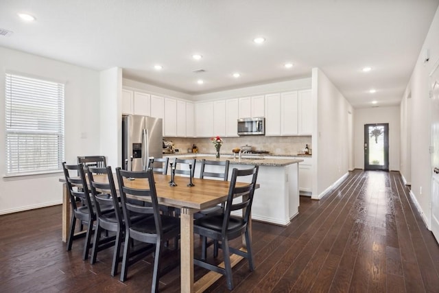 8018 Royal Palm Dr, Fulshear, TX 77441 - dining room featuring dark wood finished floors, plenty of natural light, baseboards, and recessed lighting