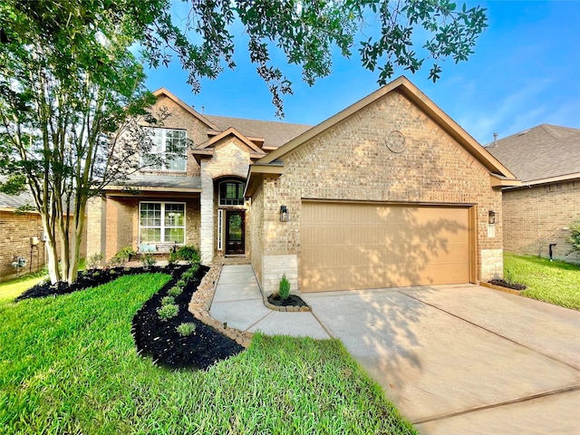 210 Black Swan Pl, The Woodlands, TX 77354 - view of front of property with a garage, driveway, brick siding, and a front yard