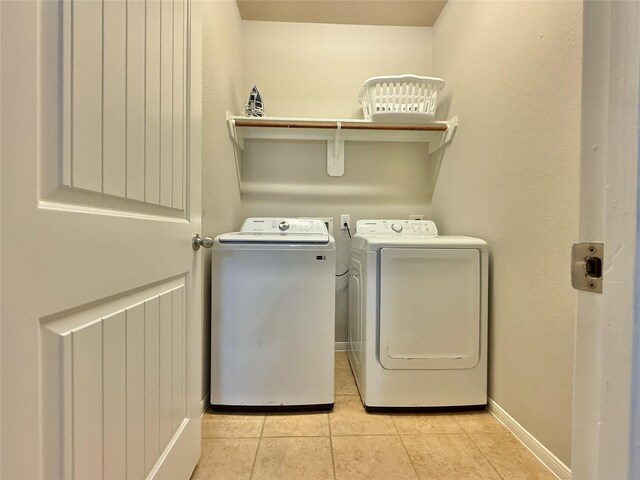 210 Black Swan Pl, The Woodlands, TX 77354 - washroom with separate washer and dryer, light tile patterned flooring, and baseboards