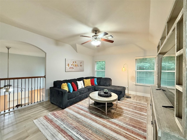 210 Black Swan Pl, The Woodlands, TX 77354 - living room with ceiling fan, wood finished floors, arched walkways, baseboards, and vaulted ceiling