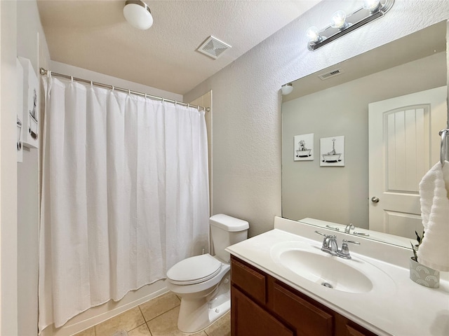 210 Black Swan Pl, The Woodlands, TX 77354 - bathroom featuring toilet, vanity, tile patterned flooring, a textured wall, and a textured ceiling