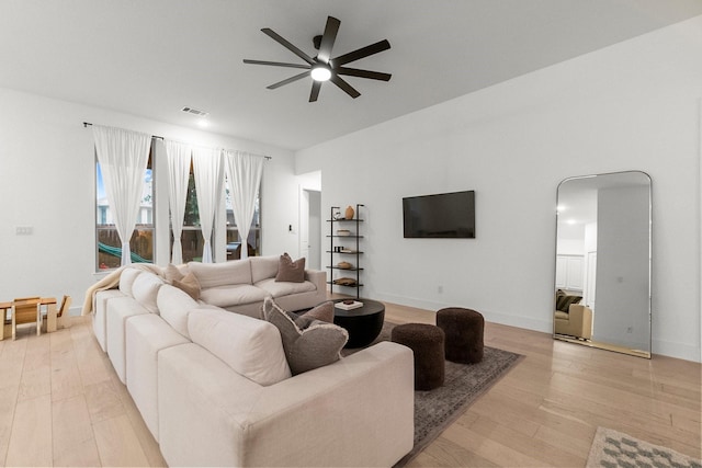 17460 Chestnut Cove Dr, Conroe, TX 77302 - living area with a ceiling fan, light wood finished floors, and baseboards