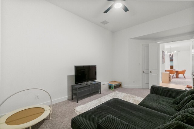 17460 Chestnut Cove Dr, Conroe, TX 77302 - carpeted living room with baseboards, a chandelier, and a ceiling fan