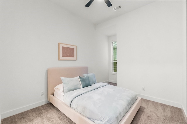 17460 Chestnut Cove Dr, Conroe, TX 77302 - carpeted bedroom with baseboards and ceiling fan