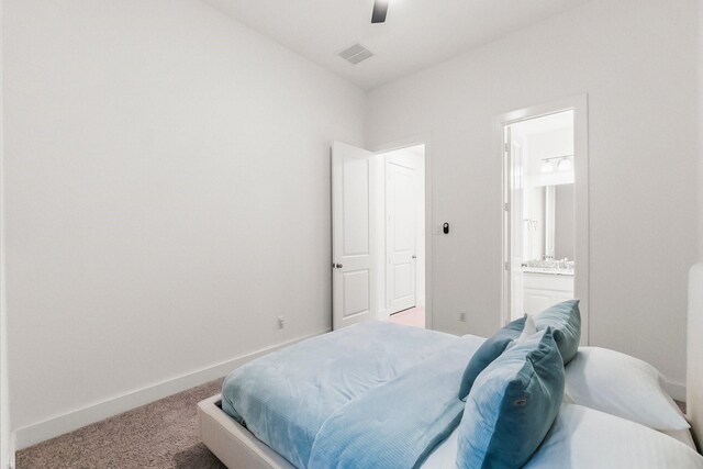 17460 Chestnut Cove Dr, Conroe, TX 77302 - carpeted bedroom with ensuite bathroom, baseboards, and a ceiling fan