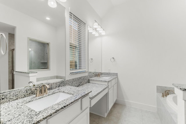 17460 Chestnut Cove Dr, Conroe, TX 77302 - bathroom featuring double vanity, a garden tub, tile patterned floors, and baseboards
