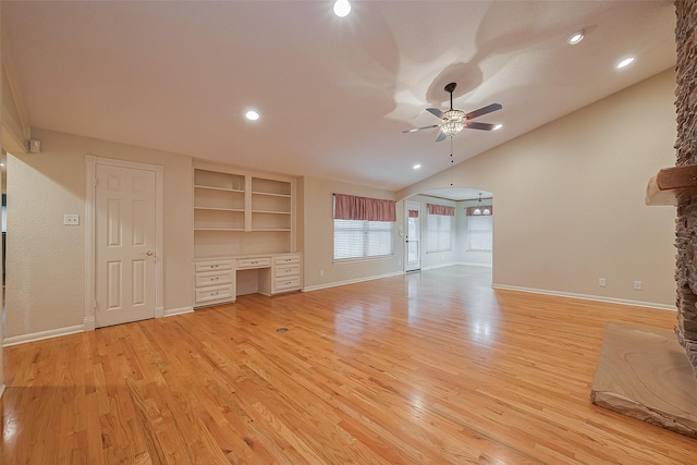 2718 Silver Falls Dr, Kingwood, TX 77339 - unfurnished living room featuring a ceiling fan, vaulted ceiling, built in study area, light wood-style flooring, and recessed lighting