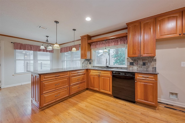 2718 Silver Falls Dr, Kingwood, TX 77339 - kitchen with black dishwasher, light wood finished floors, backsplash, dark stone counters, and ornamental molding