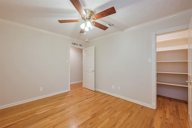 2718 Silver Falls Dr, Kingwood, TX 77339 - spare room featuring light wood finished floors, a ceiling fan, a textured ceiling, and crown molding