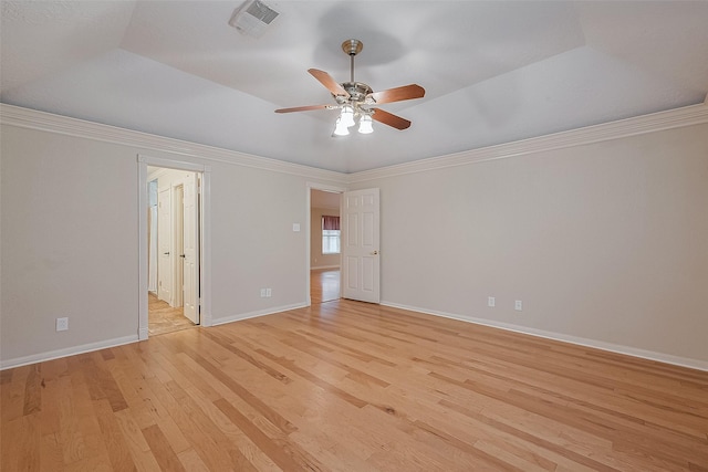 2718 Silver Falls Dr, Kingwood, TX 77339 - unfurnished room featuring light wood finished floors, a ceiling fan, crown molding, and a tray ceiling