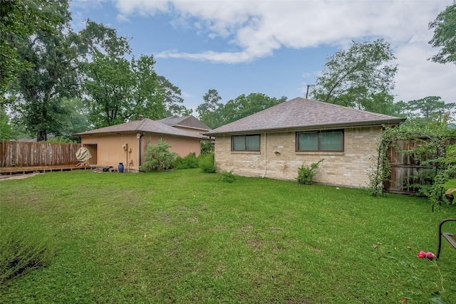 2718 Silver Falls Dr, Kingwood, TX 77339 - rear view of property featuring a fenced backyard, brick siding, and a shingled roof
