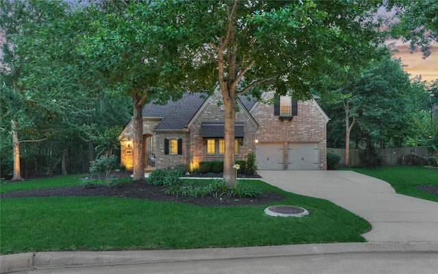 130 Playmoor Pl, Montgomery, TX 77316 - view of front facade featuring driveway, brick siding, a garage, and a shingled roof