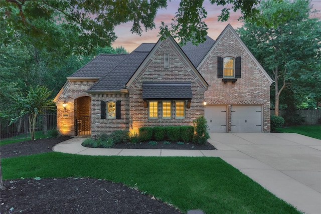 130 Playmoor Pl, Montgomery, TX 77316 - view of front facade with brick siding, driveway, an attached garage, and a shingled roof