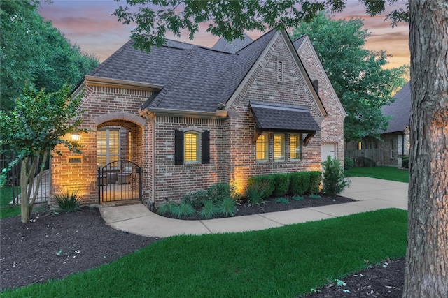 130 Playmoor Pl, Montgomery, TX 77316 - view of front of home featuring brick siding, roof with shingles, driveway, a gate, and a front yard