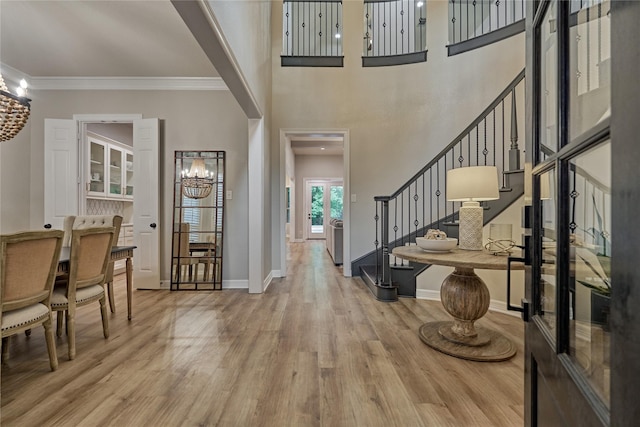 130 Playmoor Pl, Montgomery, TX 77316 - entryway featuring stairs, wood finished floors, a chandelier, baseboards, and crown molding