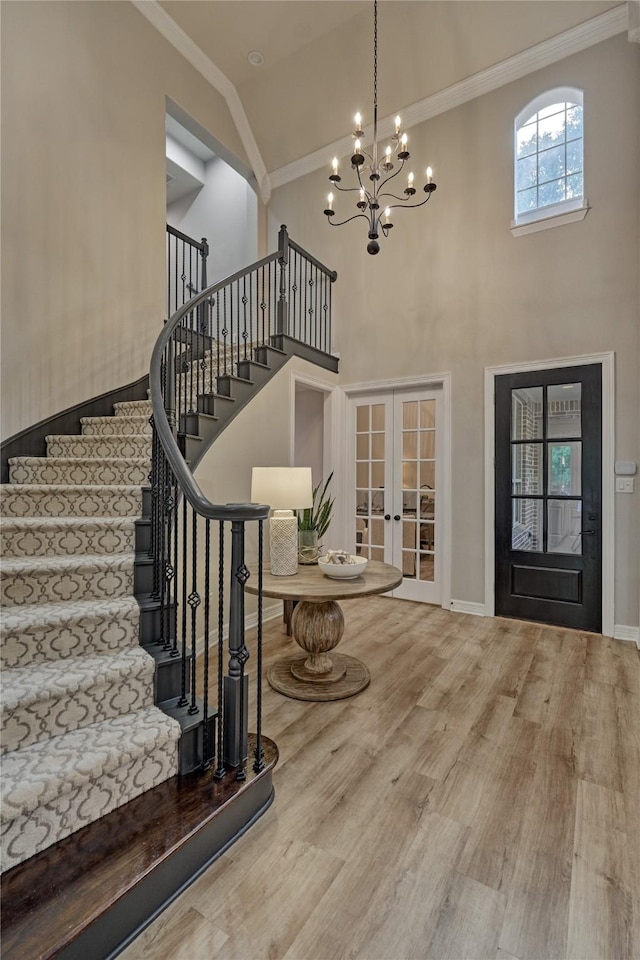 130 Playmoor Pl, Montgomery, TX 77316 - foyer entrance featuring french doors, ornamental molding, wood finished floors, a chandelier, and stairway