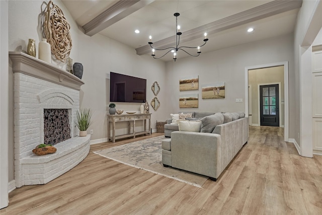 130 Playmoor Pl, Montgomery, TX 77316 - living area with beamed ceiling, light wood finished floors, a chandelier, baseboards, and a brick fireplace
