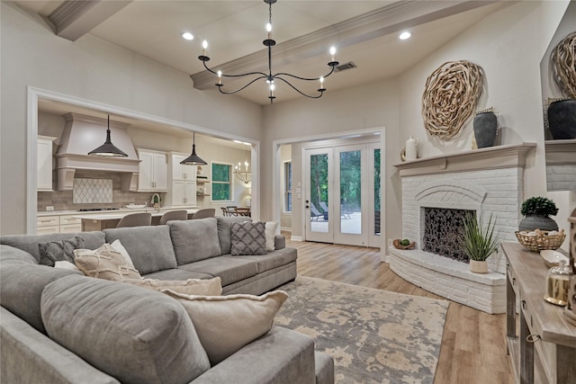 130 Playmoor Pl, Montgomery, TX 77316 - living room featuring a chandelier, light wood-style floors, recessed lighting, a fireplace, and beamed ceiling