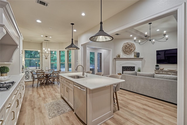 130 Playmoor Pl, Montgomery, TX 77316 - kitchen with a chandelier, appliances with stainless steel finishes, a sink, recessed lighting, and light wood-style floors