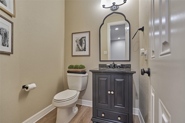 130 Playmoor Pl, Montgomery, TX 77316 - half bath featuring toilet, wood finished floors, vanity, and baseboards