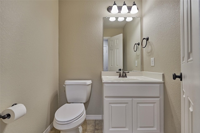 130 Playmoor Pl, Montgomery, TX 77316 - bathroom featuring toilet, vanity, tile patterned floors, and baseboards