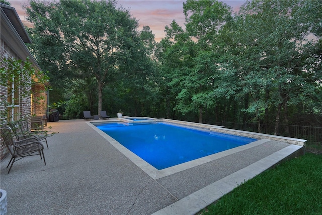 130 Playmoor Pl, Montgomery, TX 77316 - pool at dusk with an in-ground hot tub, a patio, and an outdoor pool