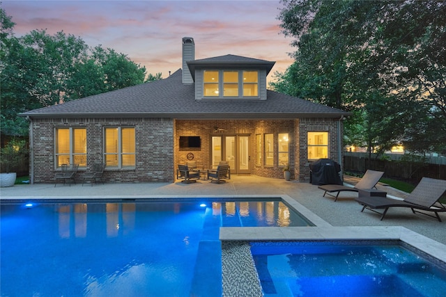 130 Playmoor Pl, Montgomery, TX 77316 - back of property featuring brick siding, a chimney, a patio area, and an exterior structure