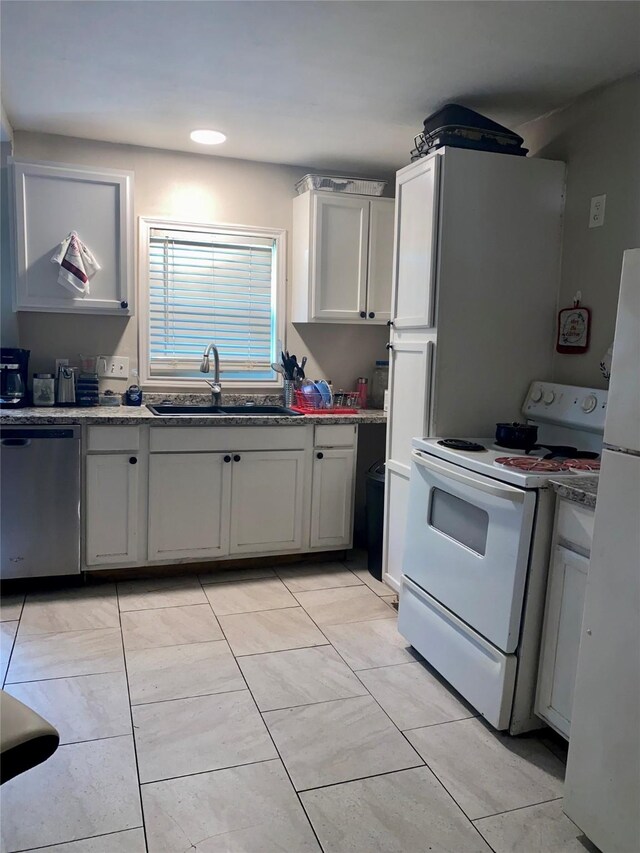 6706 Tippett St, Houston, TX 77091 - kitchen featuring a sink, white appliances, and light tile patterned floors