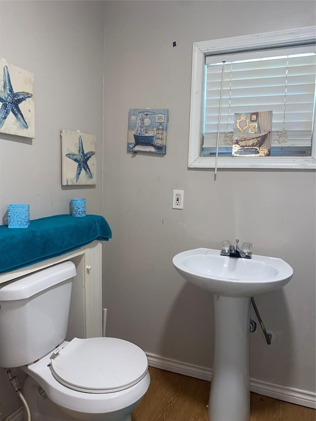 6706 Tippett St, Houston, TX 77091 - half bathroom featuring wood finished floors, baseboards, and toilet