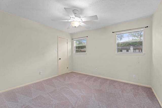 819 Maranon Ln, Houston, TX 77090 - unfurnished room with carpet flooring, ceiling fan, baseboards, and a textured ceiling