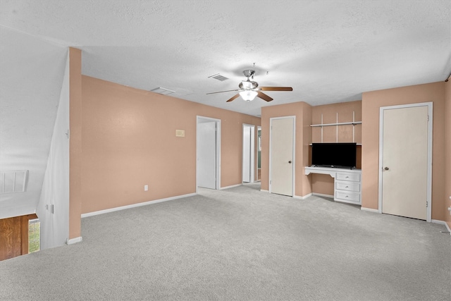 819 Maranon Ln, Houston, TX 77090 - unfurnished living room with ceiling fan, light colored carpet, a textured ceiling, baseboards, and an office area