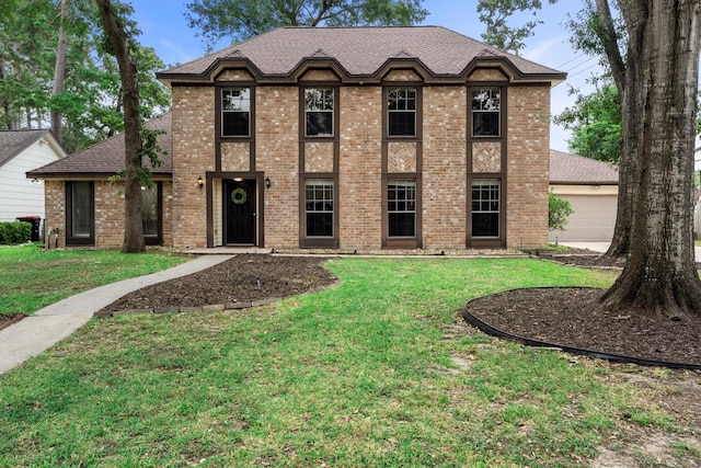 819 Maranon Ln, Houston, TX 77090 - view of front of home with a front lawn, brick siding, and a shingled roof