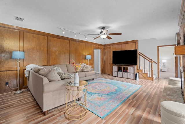 819 Maranon Ln, Houston, TX 77090 - living area featuring ceiling fan, light wood-style flooring, and stairway