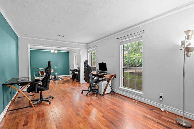 819 Maranon Ln, Houston, TX 77090 - office area featuring a textured ceiling, ornamental molding, hardwood / wood-style floors, and baseboards