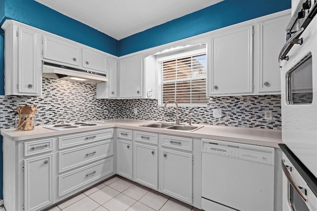 819 Maranon Ln, Houston, TX 77090 - kitchen featuring white appliances, a sink, under cabinet range hood, light countertops, and backsplash