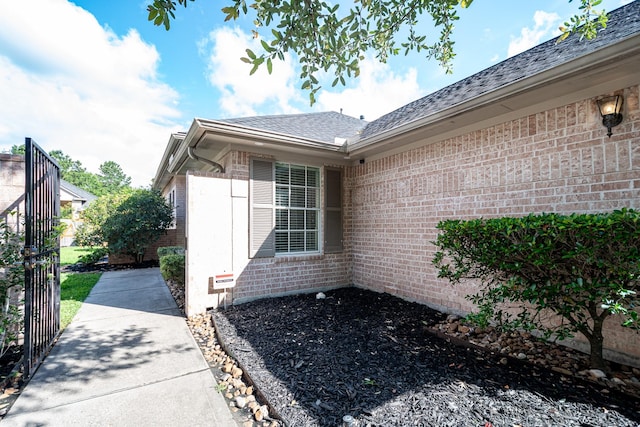 51 Eagle Mead Pl, The Woodlands, TX 77382 - view of side of property featuring brick siding and a shingled roof