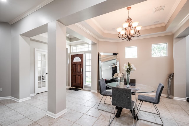 51 Eagle Mead Pl, The Woodlands, TX 77382 - dining space with a raised ceiling, plenty of natural light, light tile patterned floors, and ornamental molding