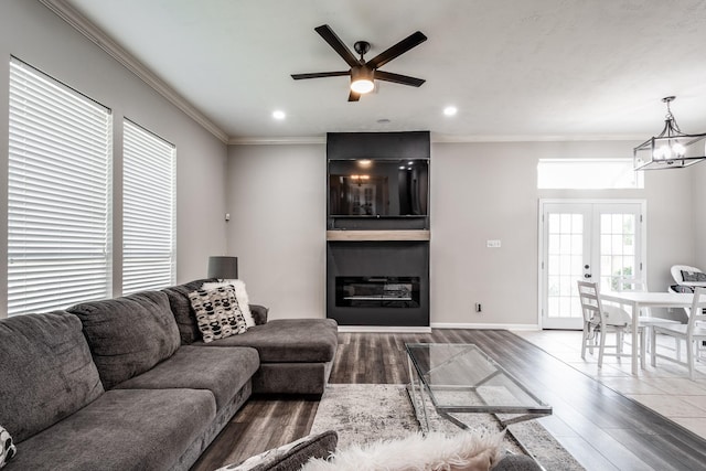 51 Eagle Mead Pl, The Woodlands, TX 77382 - living area featuring wood finished floors, ceiling fan, crown molding, a chandelier, and french doors