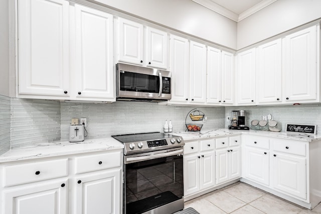 51 Eagle Mead Pl, The Woodlands, TX 77382 - kitchen featuring stainless steel appliances, crown molding, tasteful backsplash, white cabinets, and light tile patterned floors