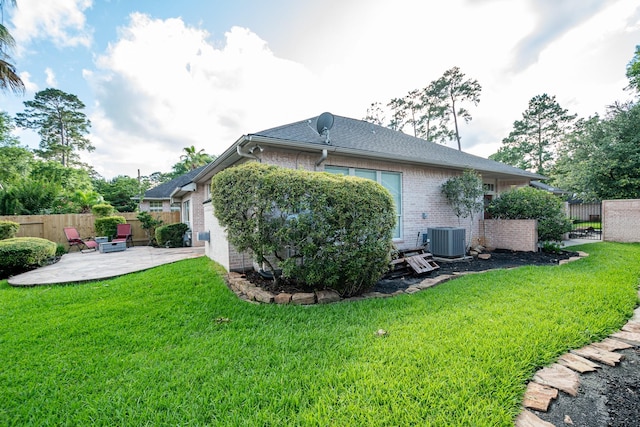 51 Eagle Mead Pl, The Woodlands, TX 77382 - back of property with a patio, central air condition unit, brick siding, and a gate