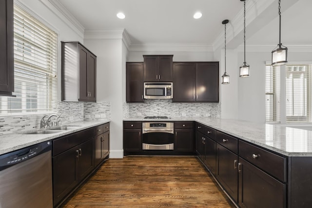 1407 Patterson St, Houston, TX 77007 - kitchen with stainless steel appliances, a sink, a peninsula, plenty of natural light, and crown molding