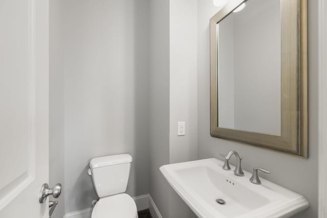 1407 Patterson St, Houston, TX 77007 - bathroom featuring a sink, toilet, and baseboards